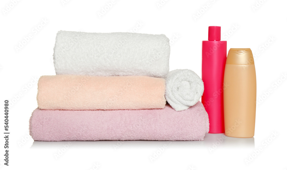 Soft terry towels and cosmetic products on white background Soft terry towels and cosmetic products on white background