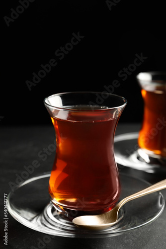 Glasses with traditional Turkish tea on black table