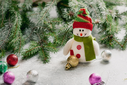 Christmas composition with snowman and green branches decorations balls