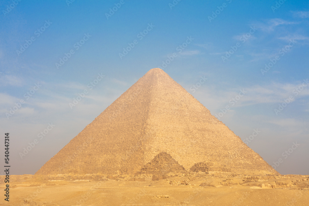 Egyptian pyramids in sand desert and clear sky.