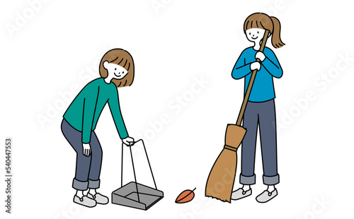 落ち葉掃除をする女性