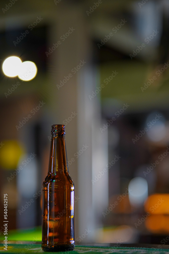 Opened beer bottle on a wooden table. Copy space, mock up.
