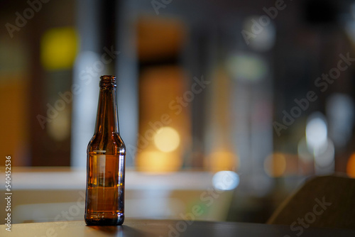 Opened beer bottle on a wooden table. Copy space, mock up. 