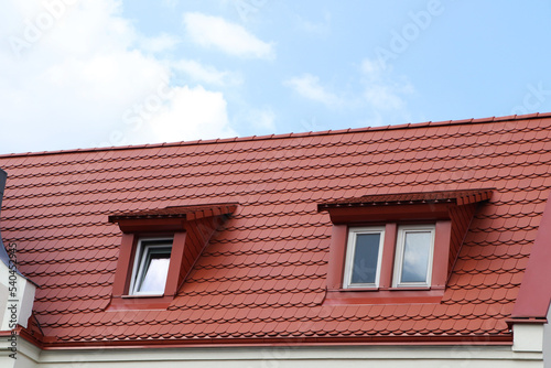 View of beautiful house with brown roof against cloudy sky