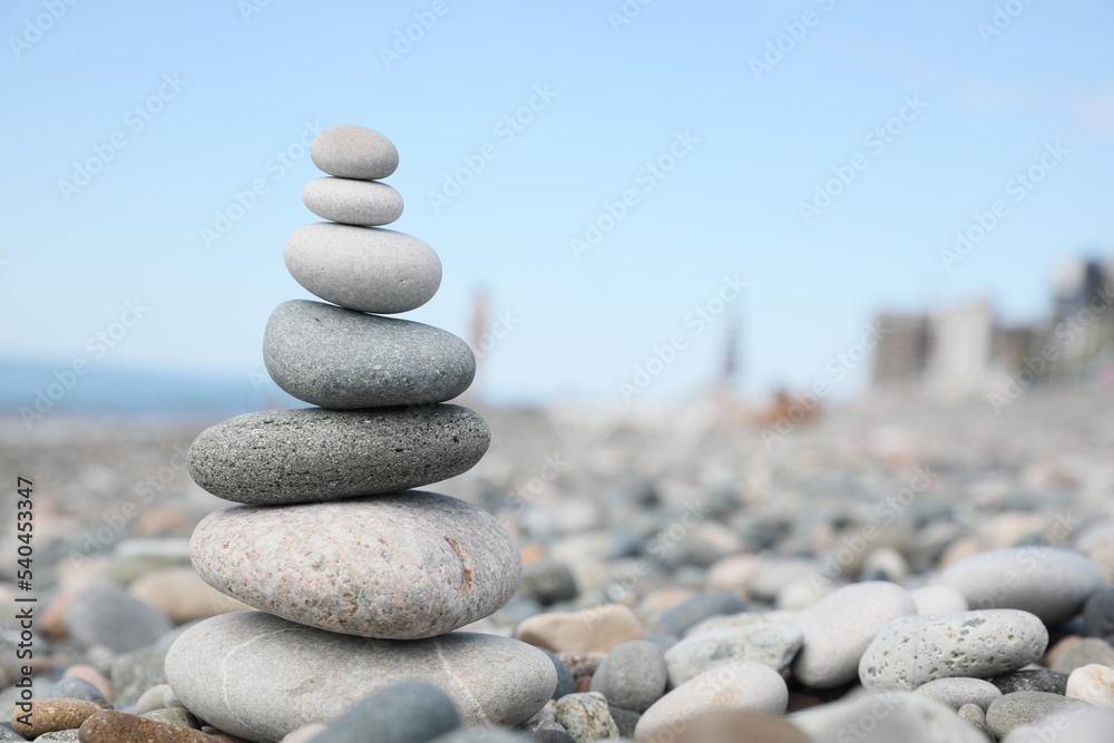 Stack of stones on beach against blurred background, closeup. Space for text Stack of stones on beach against blurred background, closeup. Space for text