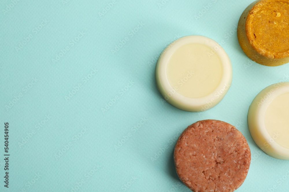 Group of solid shampoo bars on turquoise background, flat lay. Space for text Group of solid shampoo bars on turquoise background, flat lay. Space for text