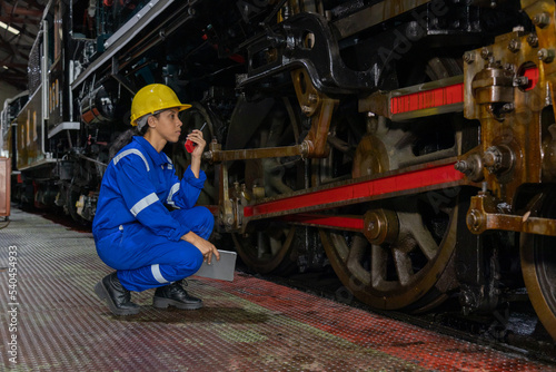 Railway engineer inspects diesel engine Report on the progress of engine parts in the factory. with safety standards