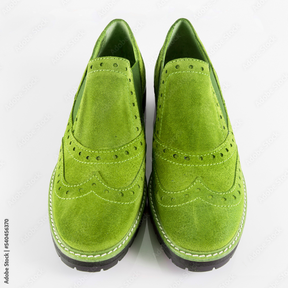 Female green leather shoes pares on white background, isolated product