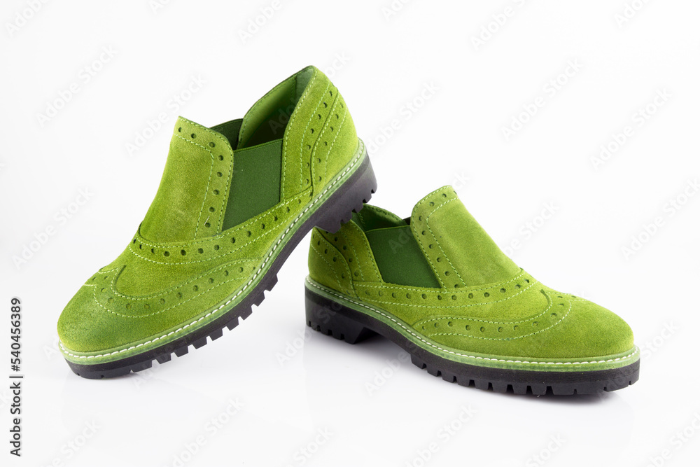 Female green leather shoes pares on white background, isolated product.