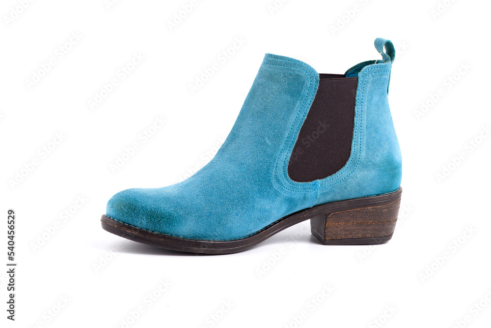 Female blue leather boot on white background, isolated product. Female blue leather boot on white background, isolated product.
