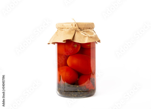 Canned tomatoes in glass jar isolated on white background