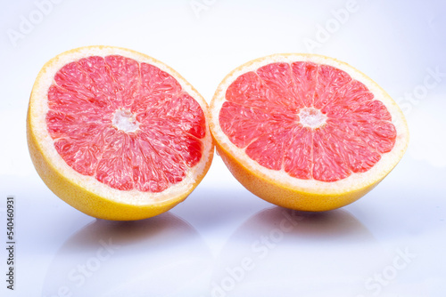juicy  fresh red grapefruit on a grey  two halves of the fruit