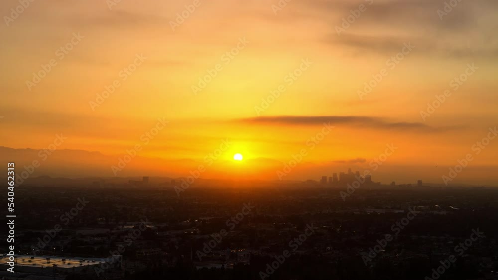 Aerial Panning Time Lapse Silhouette Of Financial District In City Mountains During Sunrise - Los Angeles, California Aerial Panning Time Lapse Silhouette Of Financial District In City Mountains During Sunrise - Los Angeles, California