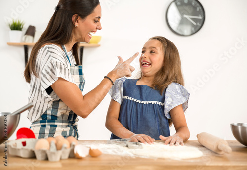 Mother and daughter making a cake