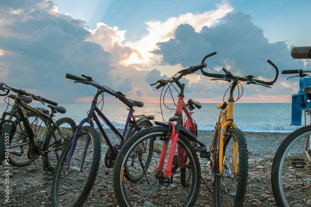 The row of bikes on the beach wit blue cloudy sky and sea background