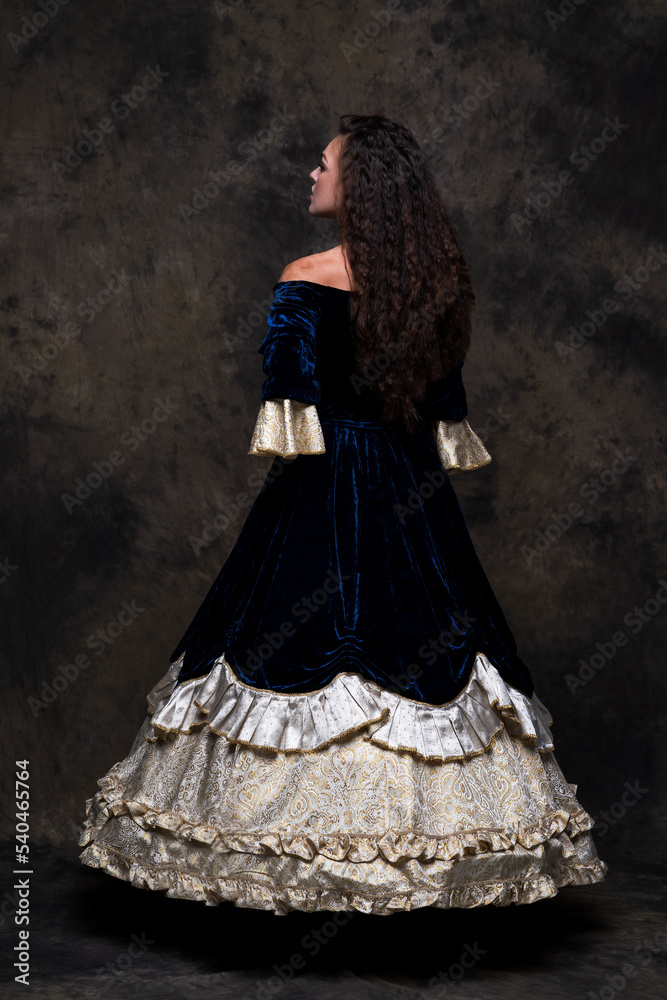 Beautiful woman in renaissance royal dress on abstract dark background Beautiful woman in renaissance royal dress on abstract dark background