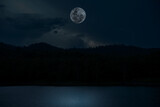 Full moon over lake in the night.