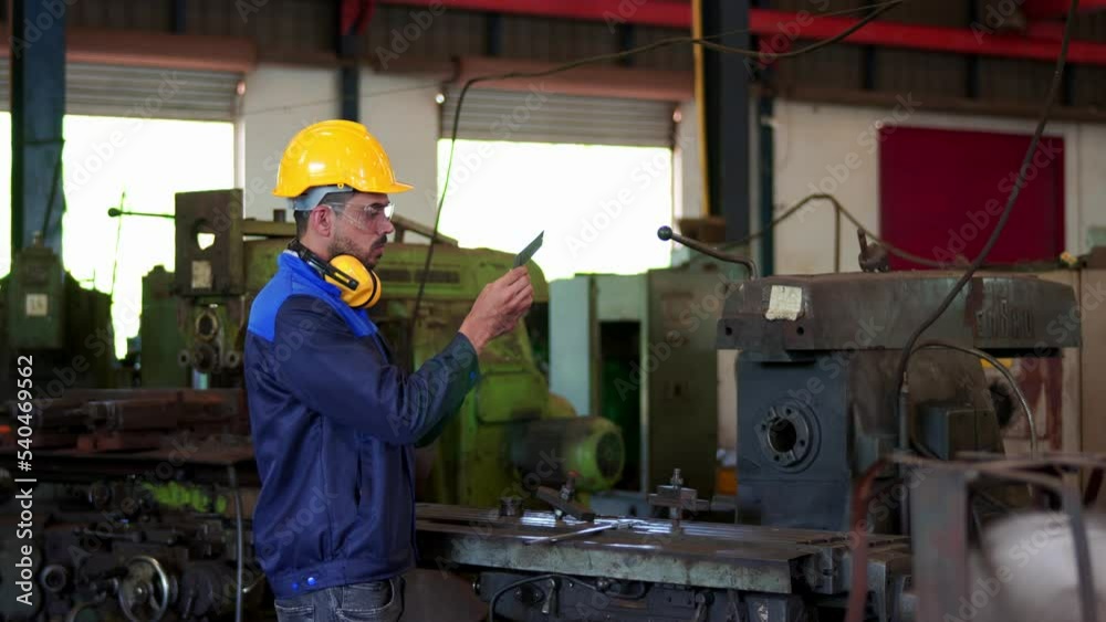 Professional industrial engineer, technician, factory worker wear hard hat, safety glasses. While checking parts tool machine heavy industry factory. Employee working in manufacturing facility. Professional industrial engineer, technician, factory worker wear hard hat, safety glasses. While checking parts tool machine heavy industry factory. Employee working in manufacturing facility.