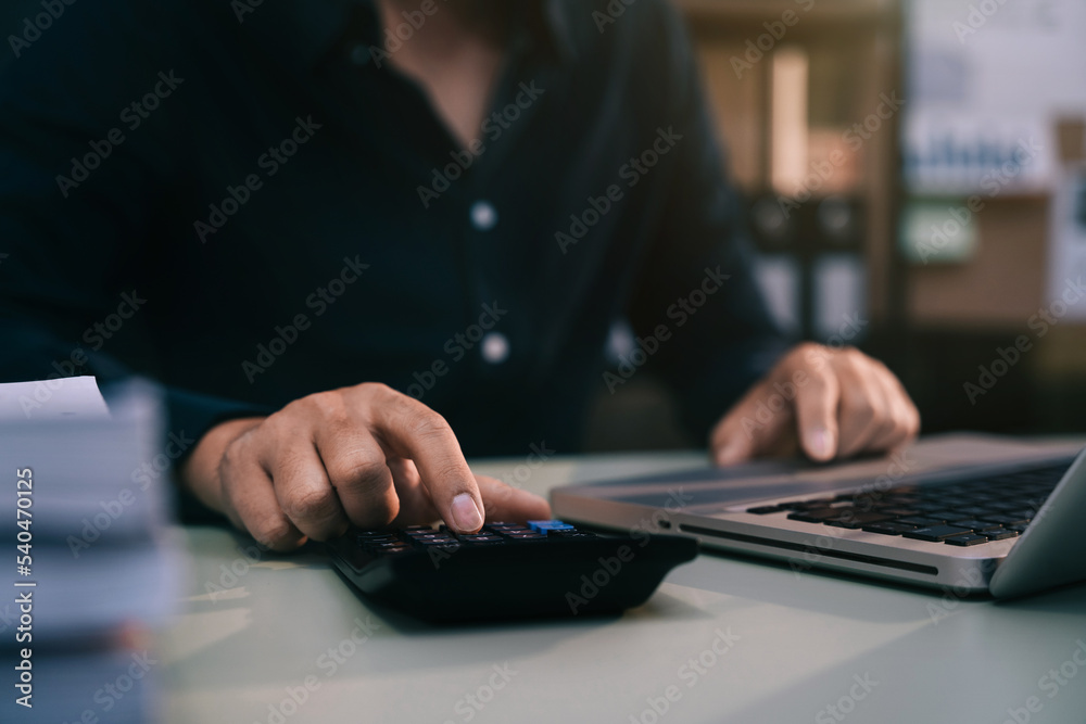 Businessmen are calculating income-expenditure and analyzing real estate investment data at office, Accounting Financial and tax systems concept. Businessmen are calculating income-expenditure and analyzing real estate investment data at office, Accounting Financial and tax systems concept.