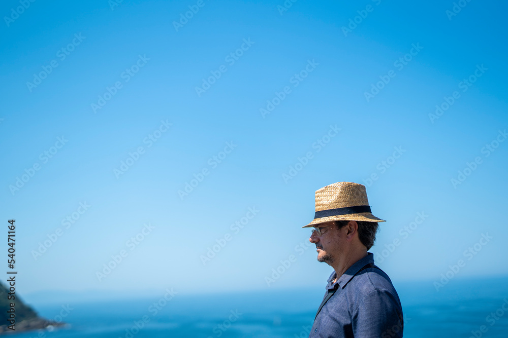 Caucasian man with a hat staring the landscape San Sebastian Caucasian man with a hat staring the landscape San Sebastian