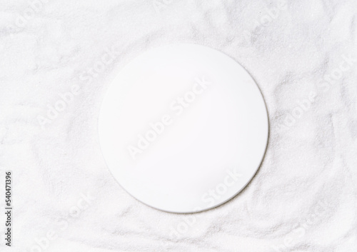 Mockup round scene on a sand. Natural pedestal for cosmetic product presentation or package advertisement. Circle stage for advertising. Top view. Copy space.