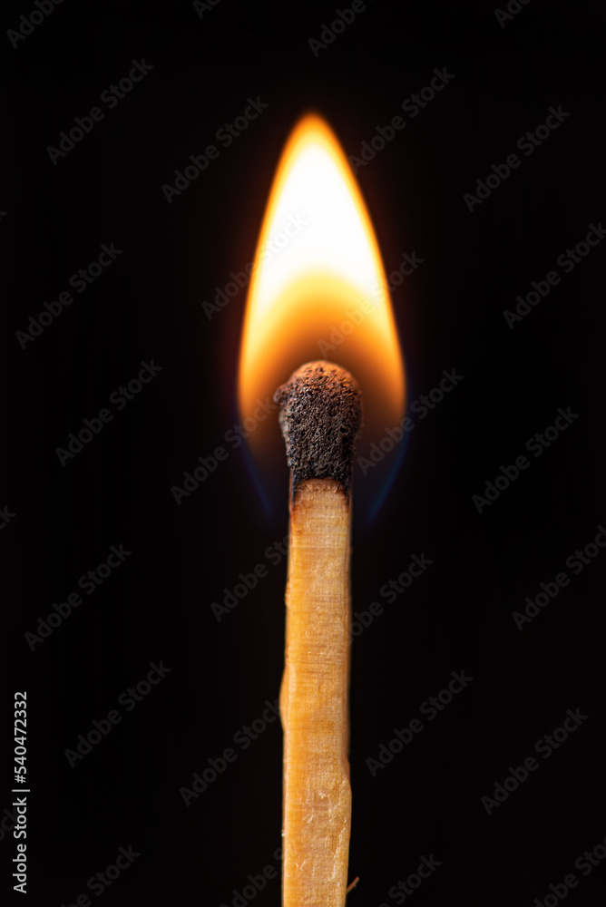 Matchstick burning in detail seen through a macro lens, black background, selective focus. Matchstick burning in detail seen through a macro lens, black background, selective focus.
