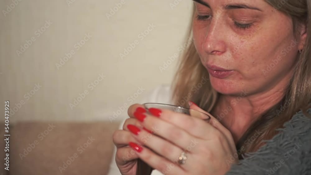 the girl is sick and blows on a hot drink so that it cools down faster. slow motion video the girl is sick and blows on a hot drink so that it cools down faster. slow motion video