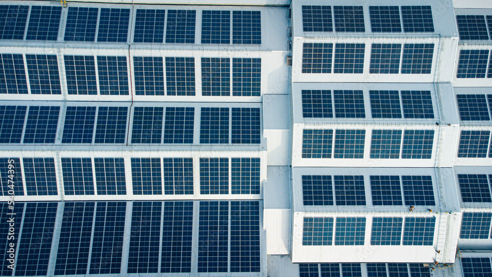 Footage over Solar cell on the roof of a large industrial factory. Solar roofs are generating renewable energy for the industry. The goal is to reduce the cost of electricity.