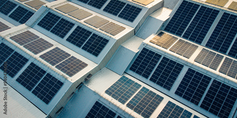 Footage over Solar cell on the roof of a large industrial factory. Solar roofs are generating renewable energy for the industry. The goal is to reduce the cost of electricity.