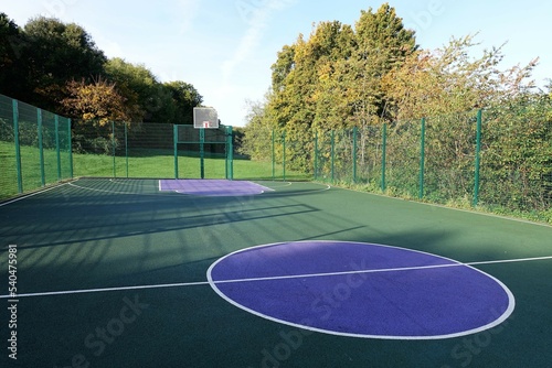 Fenced basket ball court with artificial surface photo