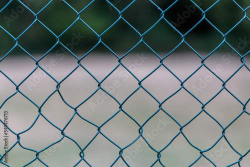 Frontal View of a Wire Mesh Fence with Soft Bokeh