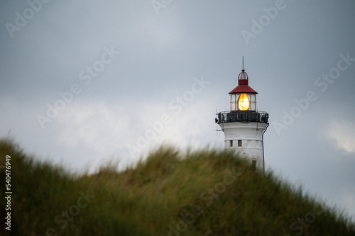 Nørre Lyngvig lighthouse behind a dune