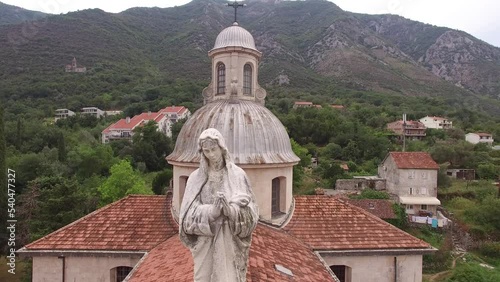 Statue of the Virgin Mary on the roof of the Church of the Nativity of the Virgin. Prcanj, Montenegro photo