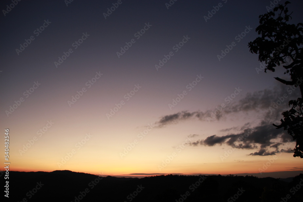 twilight evening time sunset sky background with mountain forest view 