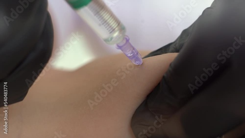 Close up of cosmetologist makes injections to burn fat on the stomach and waist of a woman. Female aesthetic cosmetology in a beauty salon.Cosmetology photo