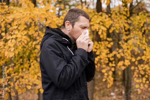 A man holds a napkin near his nose © Julia Jones