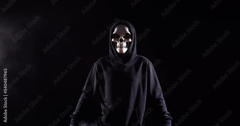 Scary Man In The Hooded Sweatshirt Wearing Halloween Mask Standing On The Black Background With Smoke
Scary Man In The Hooded Sweatshirt Wearing Halloween Mask Standing On The Black Background With Smoke