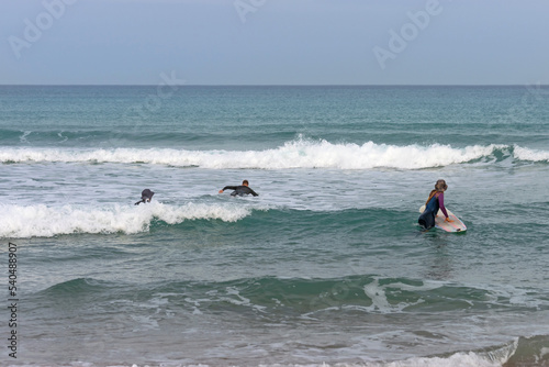 Surfers enter the sea