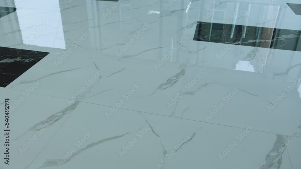 Big flooring tiles installed in beautiful home, tiles are made of ceramic material and with marmoreal textures . Granite or Marble floor .