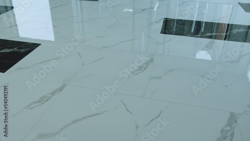 Big flooring tiles installed in beautiful home, tiles are made of ceramic material and with marmoreal textures . Granite or Marble floor .