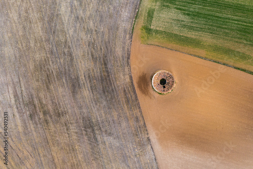 Aerial view of  round dovecote in a rural field photo