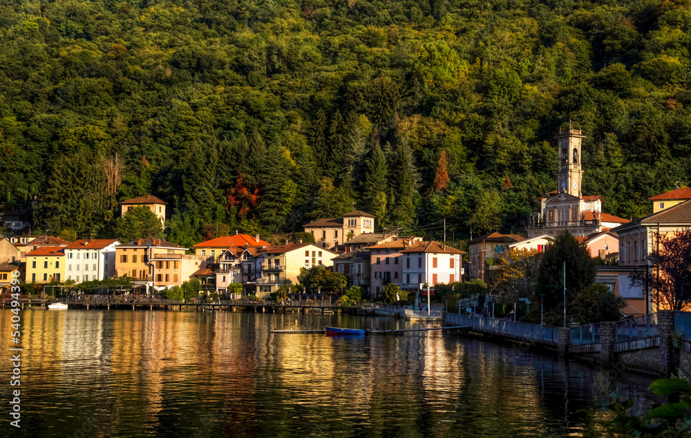 Landscape view of Porto Ceresio with evening light and water reflection