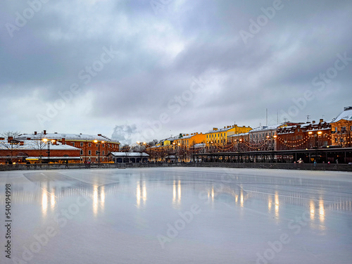 New Year's skating rink in the park in St. Petersburg. Christmas illumination and lights reflecting on the ice.