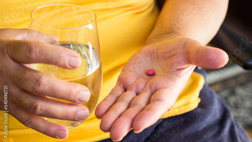 Fotografie Senior woman taking a pills