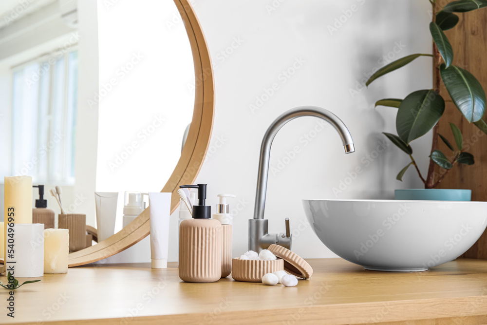 Fototapeta premium Table with modern sink and bath accessories near white wall, closeup