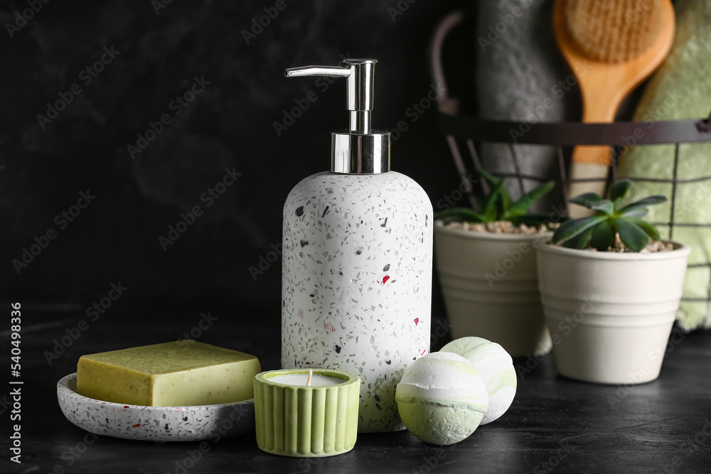 Bath supplies and candle on dark background Bath supplies and candle on dark background