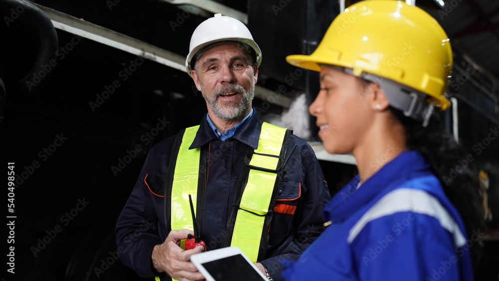 Group of apprentices with instructor at railway engineering facility. Teacher talking to apprentices at railway engineering facility Group of apprentices with instructor at railway engineering facility. Teacher talking to apprentices at railway engineering facility