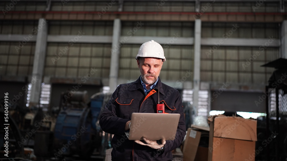 Factory engineer or foreman worker maintaining check equipment parts in factory. Factory engineer or foreman worker maintaining check equipment parts in factory.