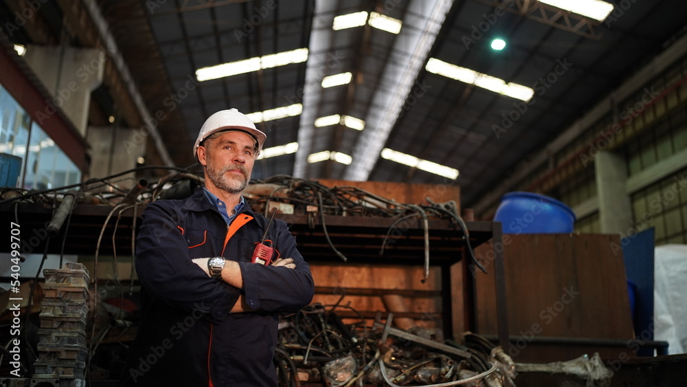 Man engineer standing on construction site or equipment maintenance work site.