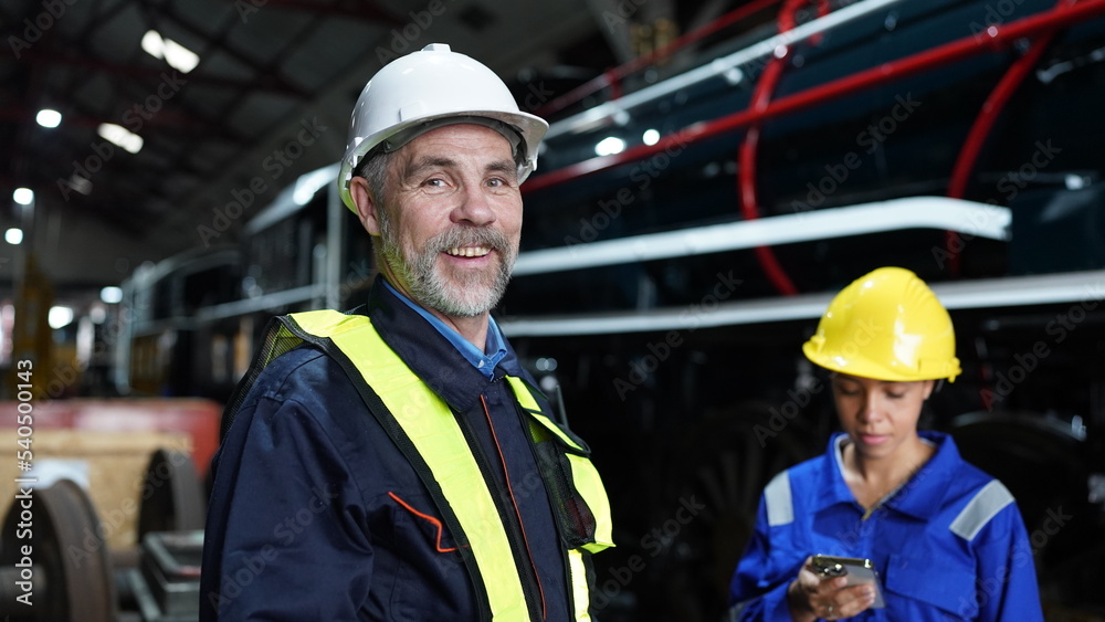 Group of apprentices with instructor at railway engineering facility. Teacher talking to apprentices at railway engineering facility Group of apprentices with instructor at railway engineering facility. Teacher talking to apprentices at railway engineering facility